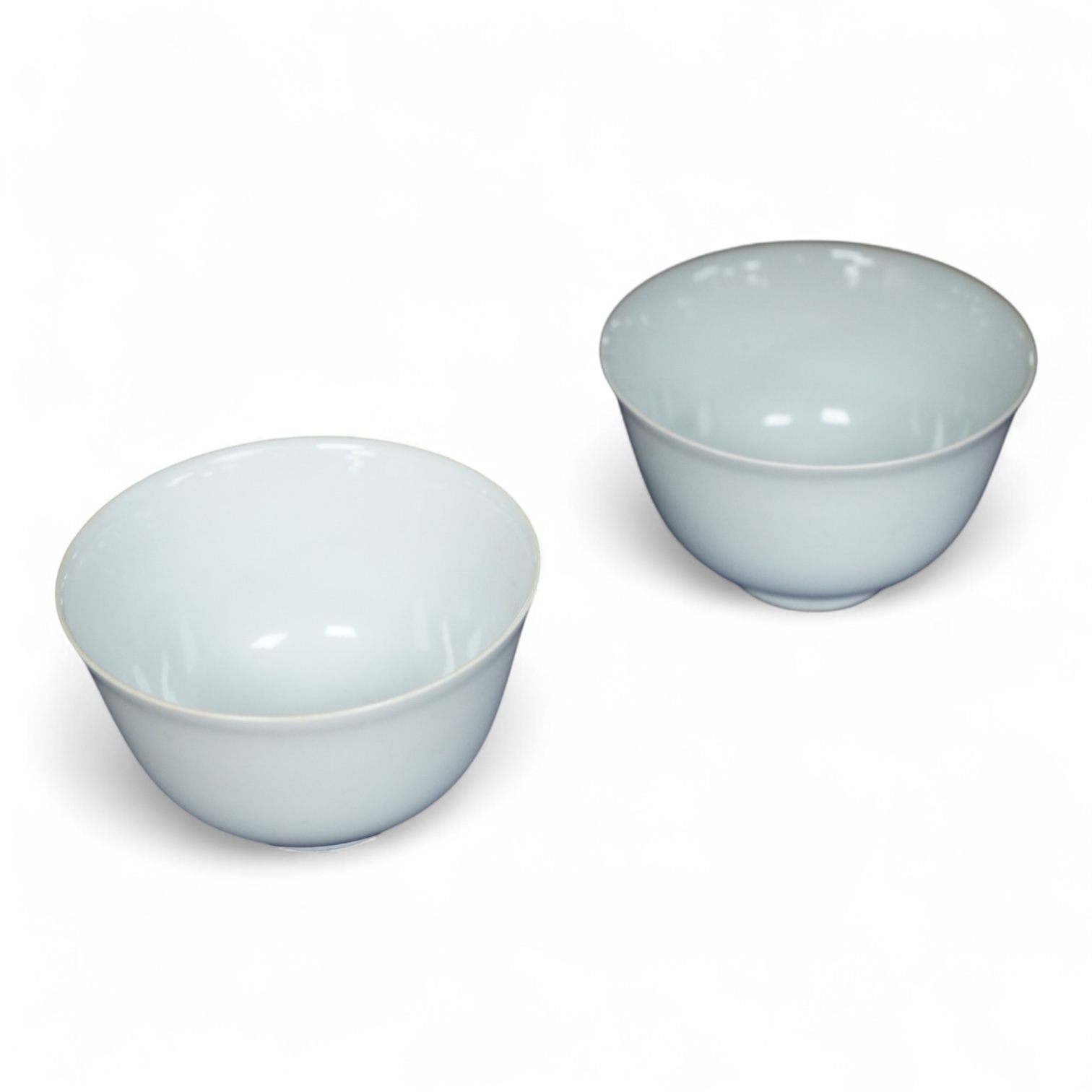 A pair of Chinese white glazed porcelain tea bowls, 6cm high